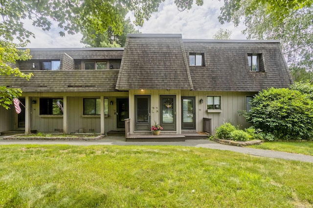 73 Landing Cir Unit 73, Suffield, CT 06078 - view of front of home featuring board and batten siding, mansard roof, a front yard, and covered porch