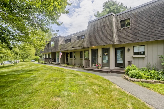 73 Landing Cir Unit 73, Suffield, CT 06078 - rear view of property featuring mansard roof, a lawn, roof with shingles, and covered porch