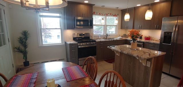 92 Sumac St, West Haven, CT 06516 - kitchen featuring stainless steel appliances, light tile patterned floors, recessed lighting, a kitchen island, and light stone counters