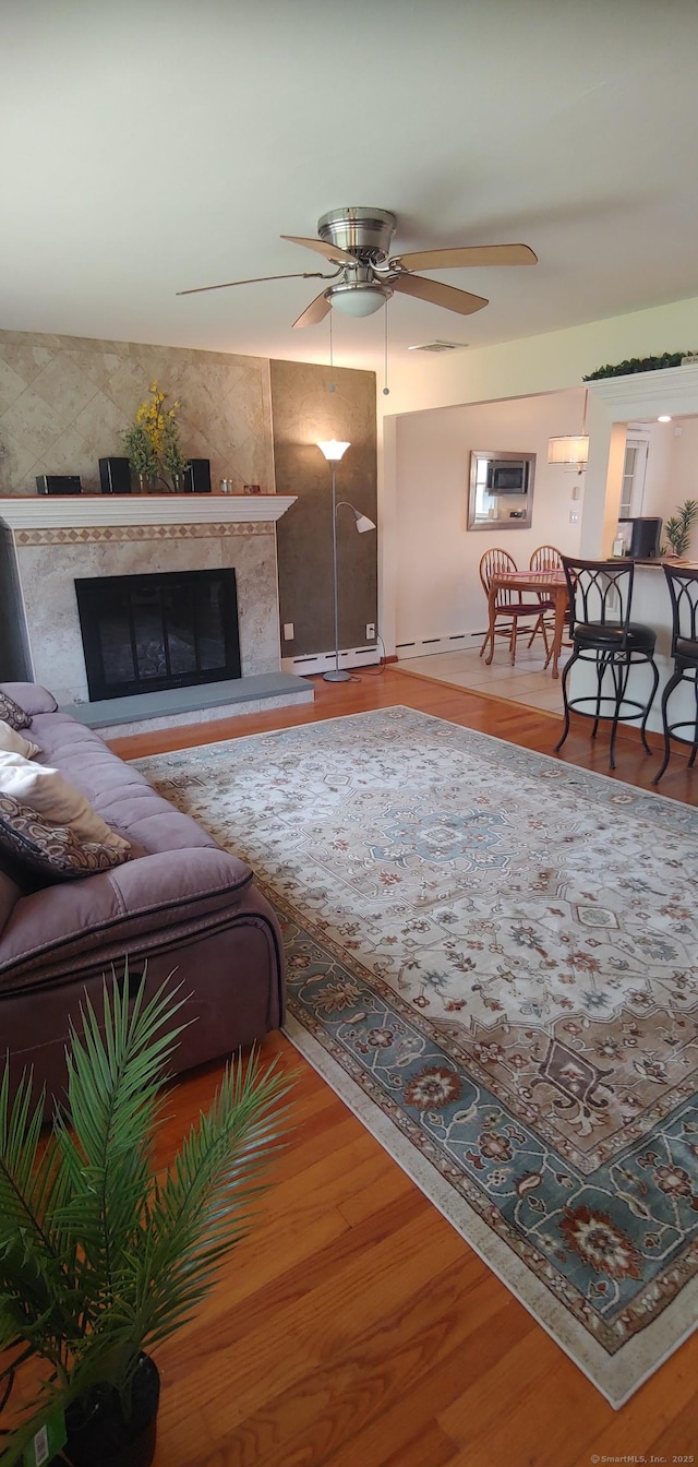 92 Sumac St, West Haven, CT 06516 - living room featuring a fireplace, ceiling fan, and wood finished floors
