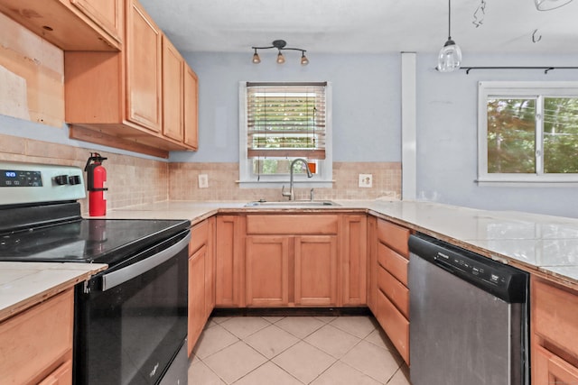 31 Richard Rd, Ledyard, CT 06335 - kitchen with stainless steel appliances, light countertops, decorative backsplash, light tile patterned floors, and hanging light fixtures