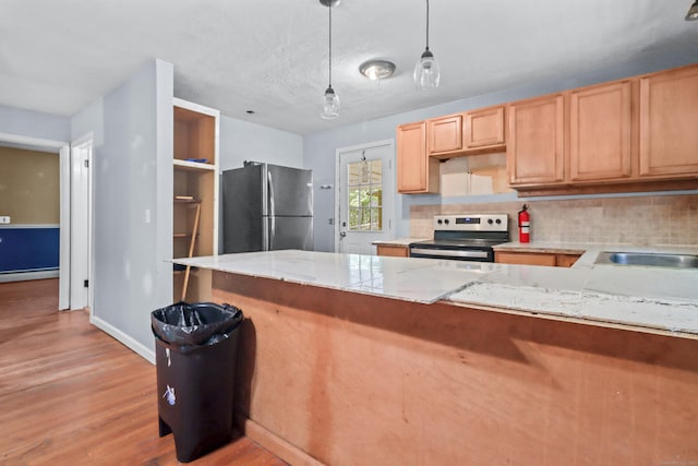 31 Richard Rd, Ledyard, CT 06335 - kitchen with stainless steel appliances, decorative backsplash, light wood-style flooring, light brown cabinetry, and hanging light fixtures
