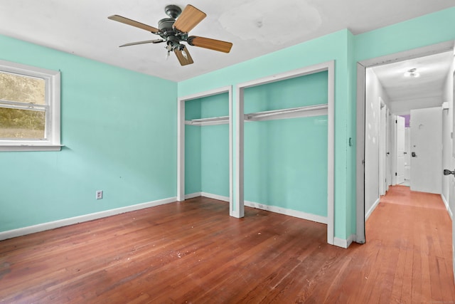 31 Richard Rd, Ledyard, CT 06335 - unfurnished bedroom with two closets, hardwood / wood-style flooring, and a ceiling fan