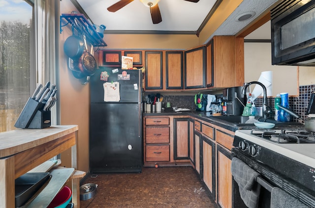 484 First Ave Unit 12, West Haven, CT 06516 - kitchen with black appliances, brown cabinetry, a ceiling fan, tasteful backsplash, and ornamental molding