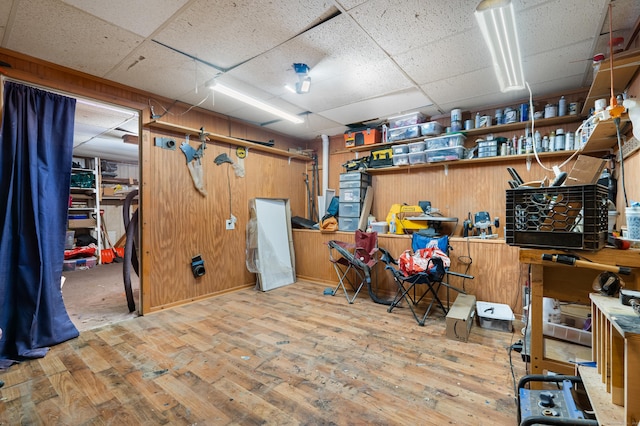484 First Ave Unit 12, West Haven, CT 06516 - basement with a paneled ceiling, hardwood / wood-style floors, a workshop area, and wooden walls