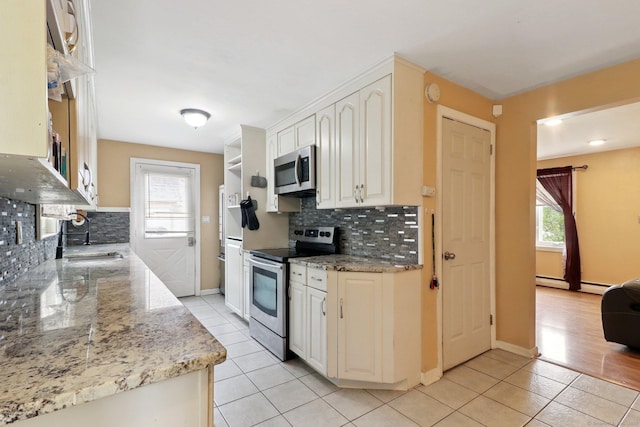97 Castle Rd, Bristol, CT 06010 - kitchen with appliances with stainless steel finishes, light tile patterned flooring, plenty of natural light, and tasteful backsplash