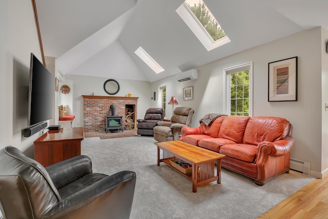 344 Oxbow Rd, Haddam, CT 06422 - living area featuring a skylight, a wall mounted air conditioner, a baseboard heating unit, a wood stove, and wood finished floors