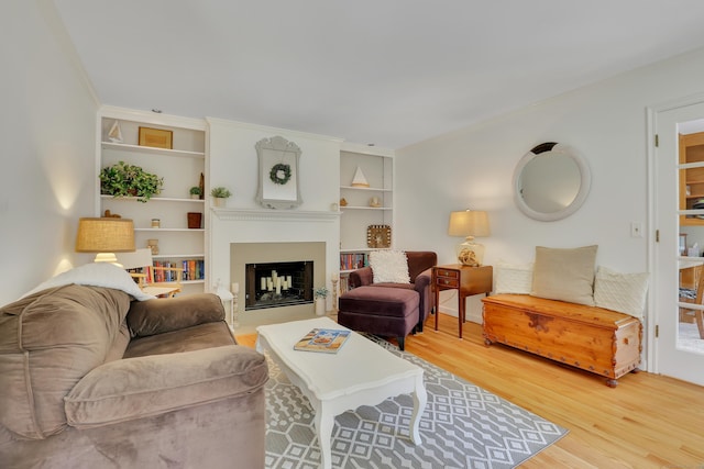 344 Oxbow Rd, Haddam, CT 06422 - living area featuring wood finished floors, built in shelves, and a fireplace