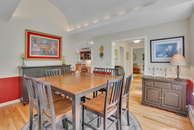 344 Oxbow Rd, Haddam, CT 06422 - dining space featuring light wood-style flooring, vaulted ceiling, and a baseboard radiator