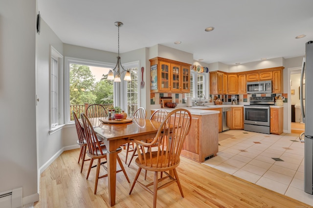 344 Oxbow Rd, Haddam, CT 06422 - dining room featuring a baseboard radiator, a chandelier, and light wood-style floors