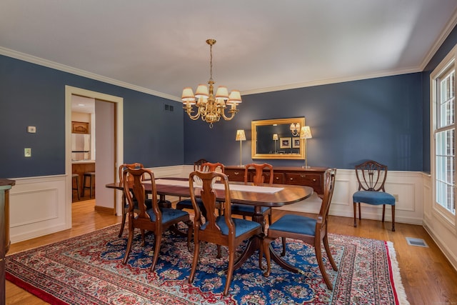 5 Billingsgate, Avon, CT 06001 - dining room with a chandelier, wood finished floors, a wainscoted wall, ornamental molding, and a decorative wall