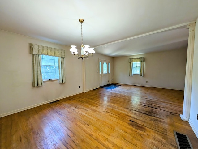 148A Westville Avenue Extension, Danbury, CT 06811 - spare room with a chandelier, light wood-type flooring, and ornate columns