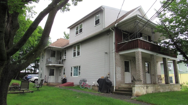 195 E Pearl St, Torrington, CT 06790 - back of property with a balcony, covered porch, and a lawn