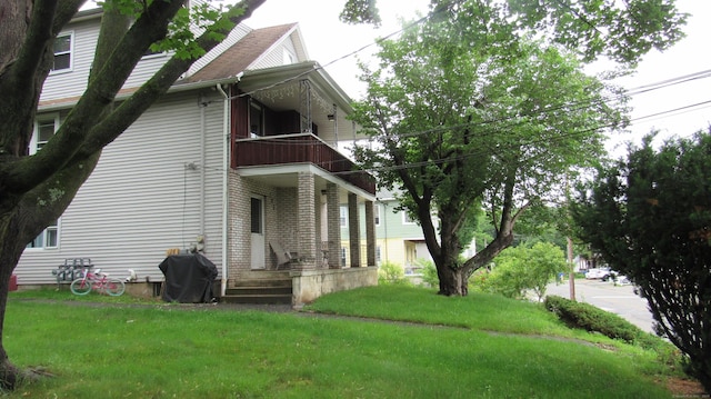 195 E Pearl St, Torrington, CT 06790 - view of side of home featuring a balcony and a lawn