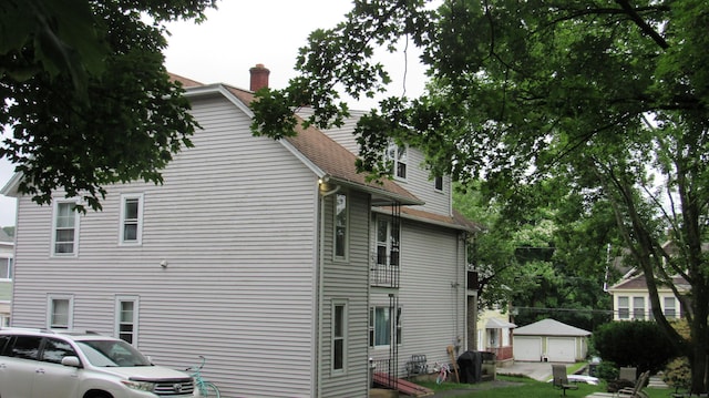 195 E Pearl St, Torrington, CT 06790 - view of side of property with a chimney and roof with shingles