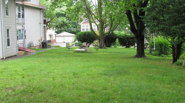 195 E Pearl St, Torrington, CT 06790 - view of green lawn with a garage and an outdoor structure