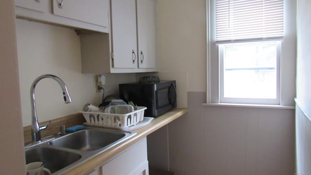 195 E Pearl St, Torrington, CT 06790 - kitchen featuring black microwave, white cabinetry, and light countertops