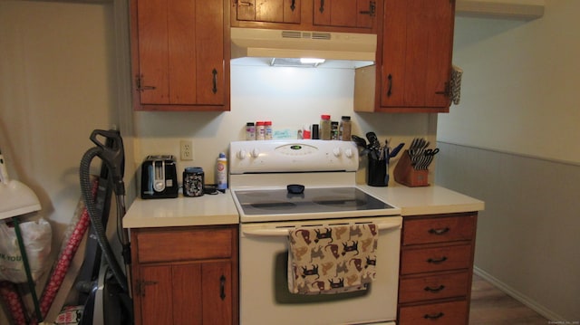 195 E Pearl St, Torrington, CT 06790 - kitchen featuring electric stove, under cabinet range hood, light countertops, and brown cabinets