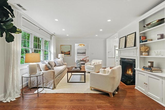 566 Hoyt St, Darien, CT 06820 - living area featuring a fireplace, dark wood finished floors, crown molding, recessed lighting, and built in shelves