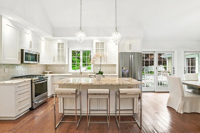 566 Hoyt St, Darien, CT 06820 - kitchen featuring stainless steel appliances, a chandelier, dark wood-style flooring, glass insert cabinets, and white cabinetry