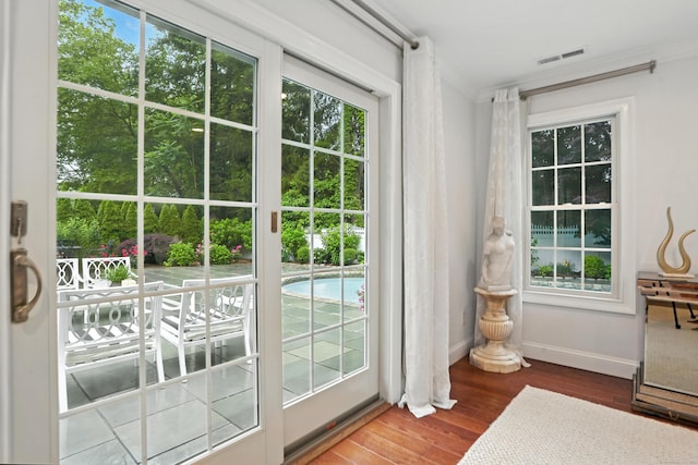566 Hoyt St, Darien, CT 06820 - doorway with plenty of natural light, wood finished floors, and ornamental molding