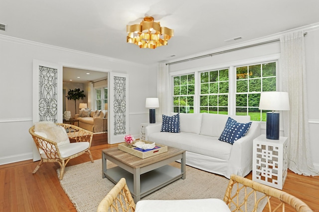 566 Hoyt St, Darien, CT 06820 - living room featuring wood finished floors, crown molding, and a chandelier