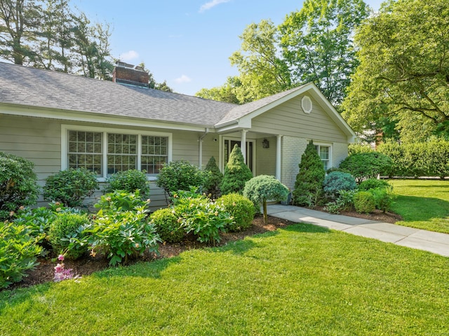 566 Hoyt St, Darien, CT 06820 - ranch-style house featuring a chimney, a front yard, a shingled roof, and brick siding