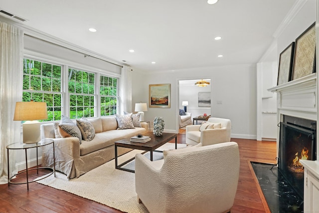 566 Hoyt St, Darien, CT 06820 - living area with ornamental molding, a fireplace with flush hearth, wood finished floors, and recessed lighting