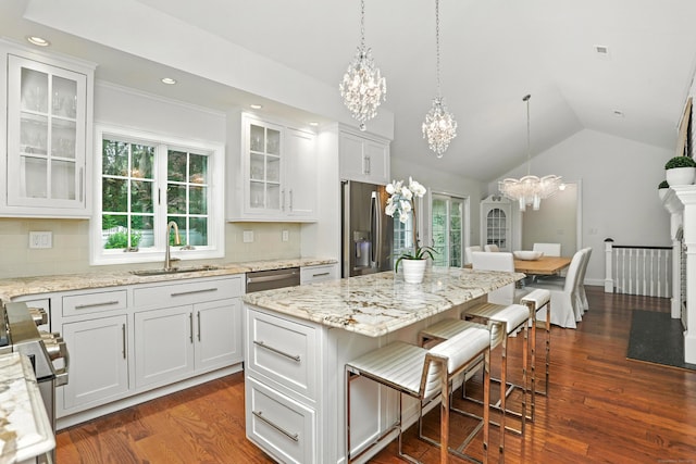 566 Hoyt St, Darien, CT 06820 - kitchen featuring a chandelier, stainless steel appliances, dark wood-style floors, lofted ceiling, and tasteful backsplash