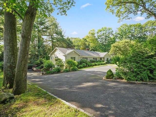 566 Hoyt St, Darien, CT 06820 - view of front of property featuring asphalt driveway and a chimney