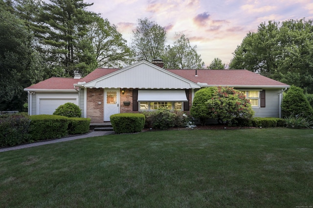 32 Butternut Ridge Rd, Waterbury, CT 06706 - view of front of home with a chimney, a garage, a yard, and brick siding