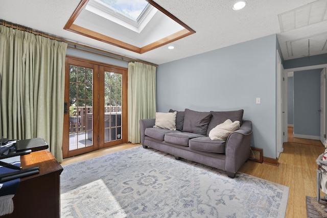 32 Butternut Ridge Rd, Waterbury, CT 06706 - living room featuring attic access, french doors, a skylight, wood finished floors, and recessed lighting