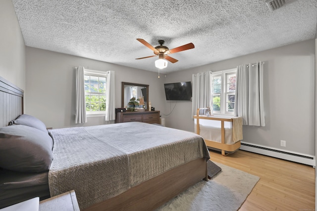 32 Butternut Ridge Rd, Waterbury, CT 06706 - bedroom with baseboard heating, wood finished floors, ceiling fan, and a textured ceiling