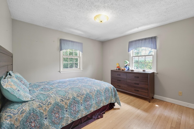 32 Butternut Ridge Rd, Waterbury, CT 06706 - bedroom featuring multiple windows, wood-type flooring, and a textured ceiling