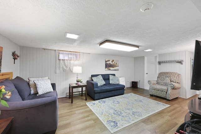 32 Butternut Ridge Rd, Waterbury, CT 06706 - living area with a baseboard heating unit, a textured ceiling, and wood finished floors