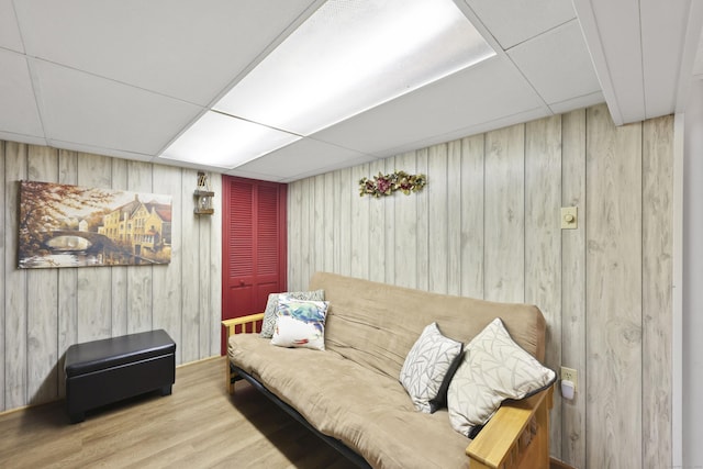 32 Butternut Ridge Rd, Waterbury, CT 06706 - living room featuring a paneled ceiling, wood finished floors, and wood walls