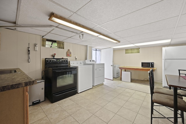 32 Butternut Ridge Rd, Waterbury, CT 06706 - kitchen featuring freestanding refrigerator, stainless steel microwave, black electric range oven, washer and clothes dryer, and a paneled ceiling