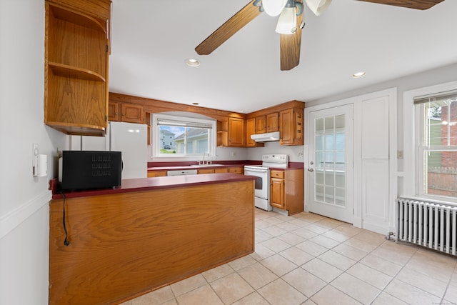 630 French St, Watertown, CT 06779 - kitchen featuring white appliances, radiator heating unit, open shelves, a peninsula, and brown cabinetry