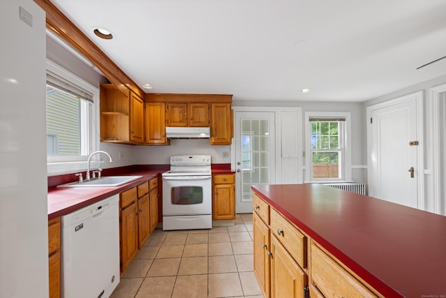 630 French St, Watertown, CT 06779 - kitchen with white appliances, under cabinet range hood, light tile patterned floors, recessed lighting, and brown cabinets