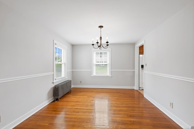 630 French St, Watertown, CT 06779 - unfurnished room with radiator heating unit, a chandelier, and wood finished floors