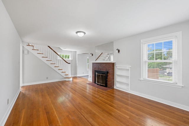 630 French St, Watertown, CT 06779 - unfurnished living room with stairway, wood finished floors, and plenty of natural light