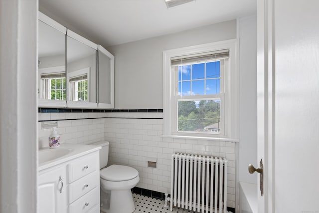 630 French St, Watertown, CT 06779 - full bath featuring radiator, vanity, tile walls, a tub to relax in, and wainscoting