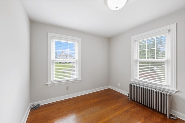 630 French St, Watertown, CT 06779 - spare room featuring radiator heating unit, plenty of natural light, and dark wood-style floors