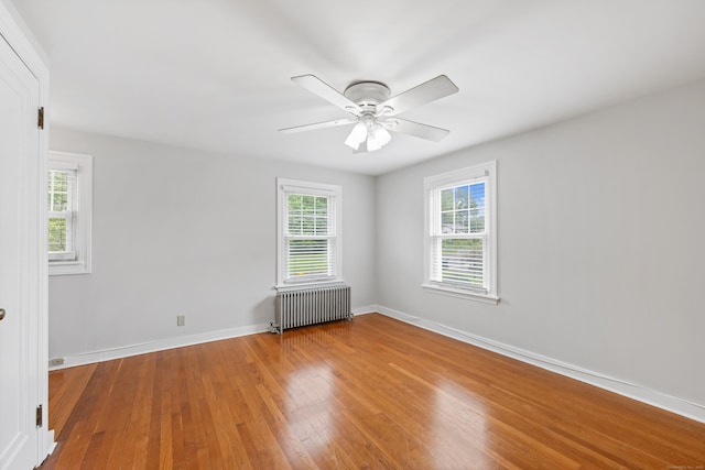 630 French St, Watertown, CT 06779 - unfurnished room featuring radiator, healthy amount of natural light, wood finished floors, and ceiling fan