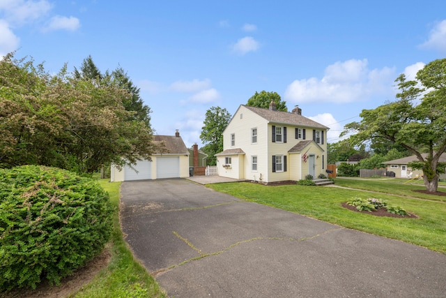 630 French St, Watertown, CT 06779 - colonial house featuring a chimney, an outbuilding, a front yard, and a garage