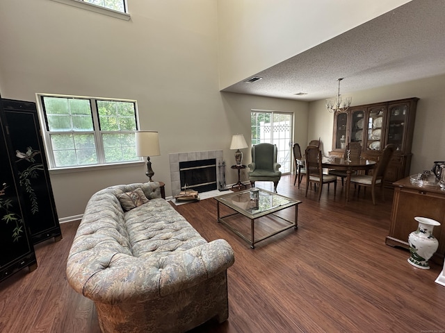 202 The Mews Unit 202, Rocky Hill, CT 06067 - living room featuring a chandelier, dark wood-style floors, a fireplace, and a towering ceiling