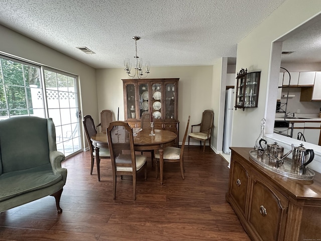 202 The Mews Unit 202, Rocky Hill, CT 06067 - dining space with dark wood-type flooring, a textured ceiling, and a chandelier