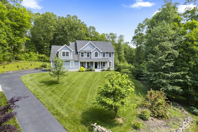 257 Ichabod Rd, Southbury, CT 06488 - colonial inspired home featuring a porch, a front lawn, and asphalt driveway