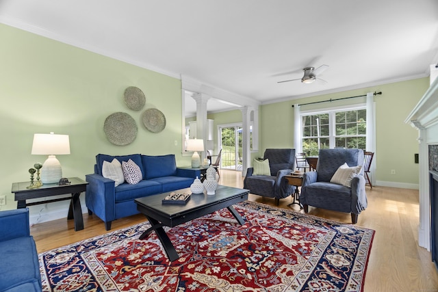257 Ichabod Rd, Southbury, CT 06488 - living area featuring decorative columns, light wood-type flooring, plenty of natural light, crown molding, and a ceiling fan