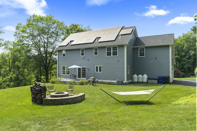 257 Ichabod Rd, Southbury, CT 06488 - back of property with an outdoor fire pit, solar panels, and a yard